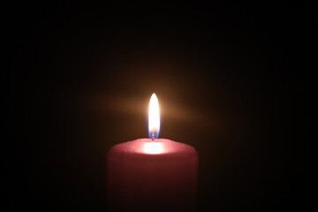 Candle fire on a black background. A burning candle.