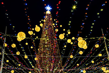 Christmas tree with colorful lights at night.
