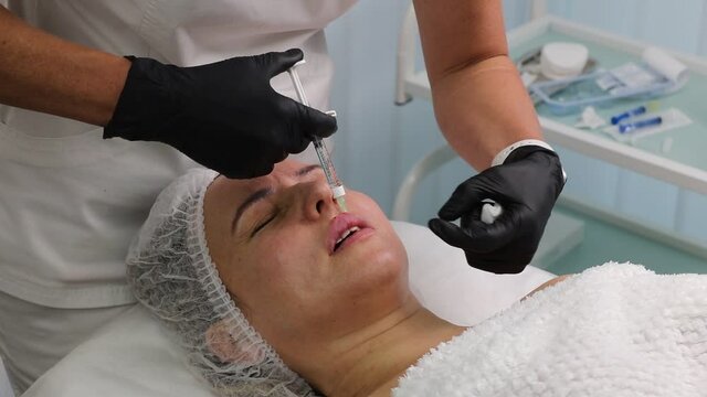 Lip augmentation and volume with fillers in a cosmetic salon