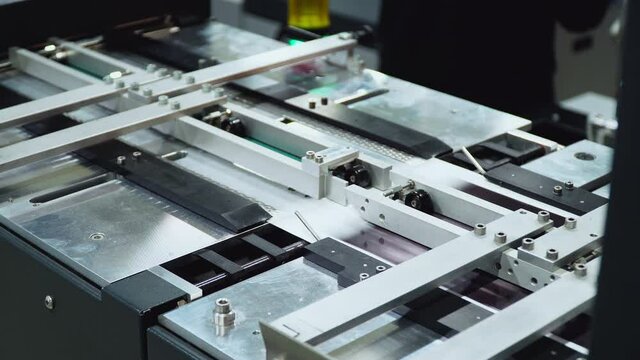 conveyor printing of photos in production. an automated machine prints photographs. factory for the production of books.