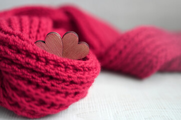 Valentines day concept with red scarf and hearts over grey background.