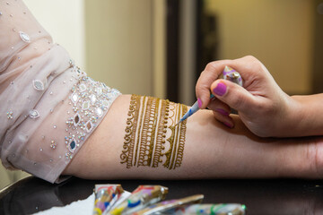 Henna art on the hand of Indian bride