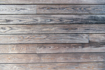 Gray wood texture background. The wooden boards are laid horizontally and have a worn look.