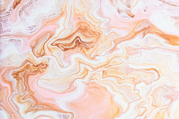 Abstract background in pink and orange with marble texture from closeup of acrylic pour art