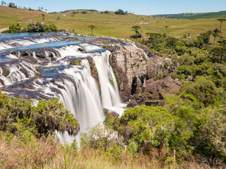 Obraz premium Waterfall with fields and forest around