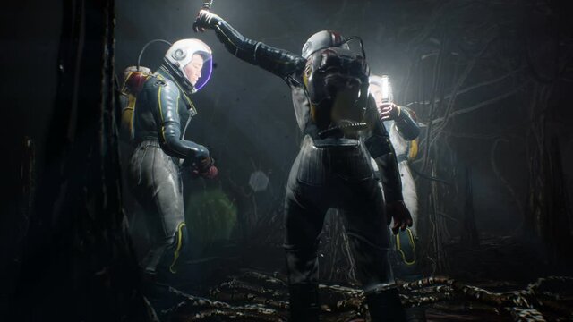 The astronauts look around in a nightmarish cave with creepy creatures on an alien and desolate planet. The concept of colonizing planets. The animation is perfect for space or sci-fi backgrounds