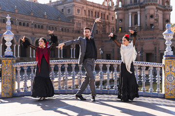 People dancing flamenco in the middle of a traditional bridge