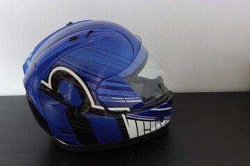 Motorcycle helmet in a blue, black, white color on a gray background
