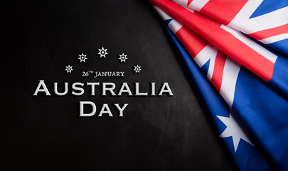 Fototapeta na wymiar Happy Australia day concept. Australian flag against dark stone background. 26 January.