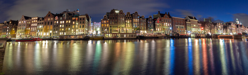Fototapeta na wymiar Panorama of the Amsterdam waterfront in night illumination.
