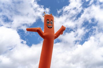 orange inflatable arm flailing tube man - obrazy, fototapety, plakaty