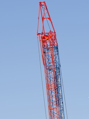 Tokyo,Japan - December 30, 2021: Crawler Crane or Luffing Jib Crawler Crane on blue sky background
