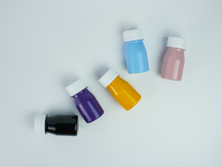 pigment resin paint in the bottle, many colors there are purple, pink, blue, orange, and black.