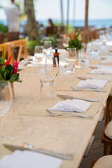 table setting at the restaurant, deck chair on the sea, table and chairs on the beach