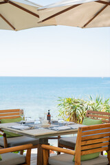 restaurant on the beach, deck chair on the sea, table and chairs on the beach