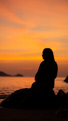 silhouette of a person sitting on a bench, sunset over the river, Patong beach