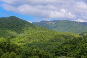 Fototapeta na wymiar The view of mountains with green forest near Kenh Ha Lake, Nha Trang City