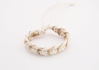 An isolated ethnic bracelet on white background. The bracelet is made off the various rope
