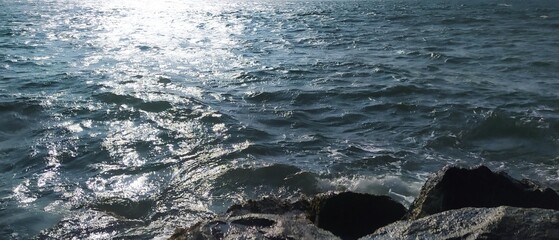 Nature landscape view of the beautiful tropical sea on a sunny day. Sun Shines on the Sea  Rocks and Horizon View