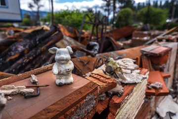 Burned down house after fire pig figurine
