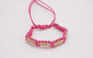 An isolated ethnic bracelet on white background. The bracelet is made off the various rope