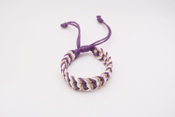 An isolated ethnic bracelet on white background. The bracelet is made off the various rope