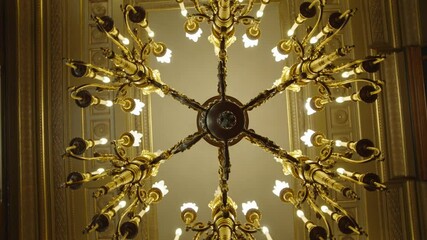 Looking Up Into Rotating Lit Chandelier In A Luxury House. Low Angle