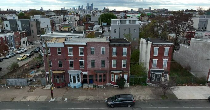 Aerial of unsafe condemned housing in USA. Poverty in urban America. Trash on sidewalk. Slumlord home apartment building for poor inner city population lifestyle.