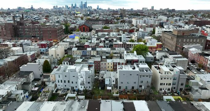 Rising aerial of urban homes in large metropolitan USA city. Powerful establishing shot of lifestyle and population growth and sprawl. Tight quarters congested theme.