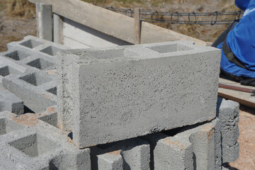 Rectangular thick concrete blocks . Gray masonry bricks, large and thick, are characterized by...
