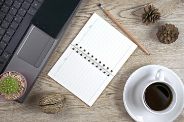 Office table with Notebook computer,smart phone.,book,pencil and cactus top view.