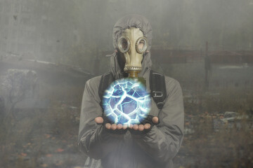 A man in a protective suit, a gas mask holds an artifact in his hands. Cosplay from the game Stalker.