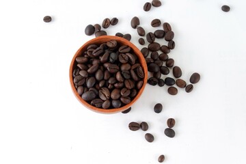 Coffee beans with wooden bowl on white background
