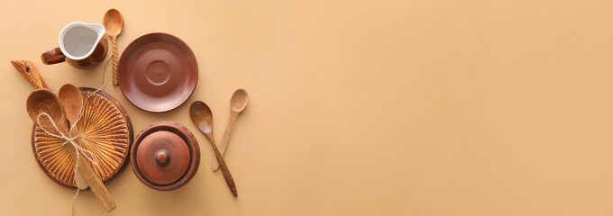 Set of stylish dinnerware on beige background with space for text