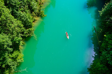 Fototapeta na wymiar Kayaking on river in forest - beautiful nature scenery