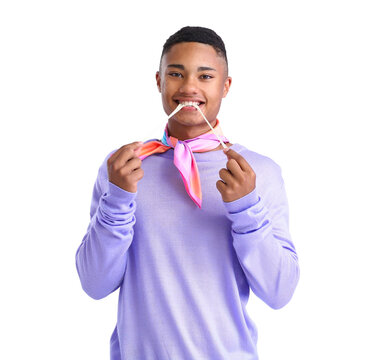 Young African-American guy in violet clothes and with chewing gum on white background