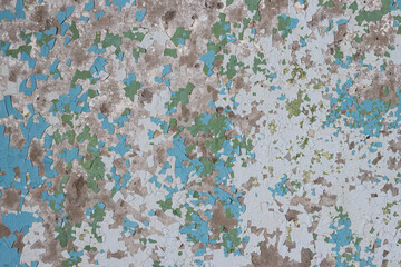 Peeling paint on the wall. Old concrete wall with cracked flaking paint. Weathered rough painted...
