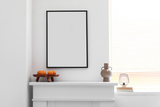Blank poster on fireplace in light living room