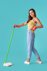 Young woman with floor mop on blue background