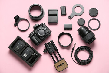 Flat lay of equipment for professional photographer on pink background