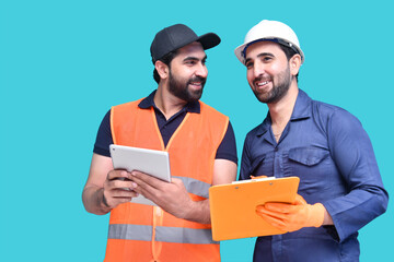 two construction worker smiling holding tab and clipboard indian pakistani model