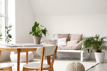 Wooden table with houseplant in light living room