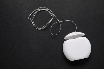 Dental floss on black background