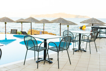 Empty table top and blurred swimming pool in tropical resort in summer banner background