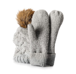 Winter mittens and hat on white background