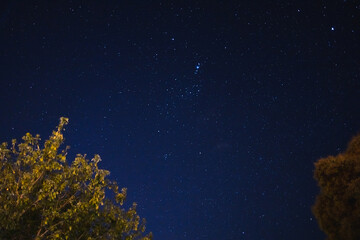 starry night with crisp sky and some clouds with a lot of constellations visible as well as some...