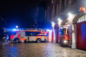 Berlin firefighters responding to a fire alarm on New Year's Eve from fire station 1300 in...