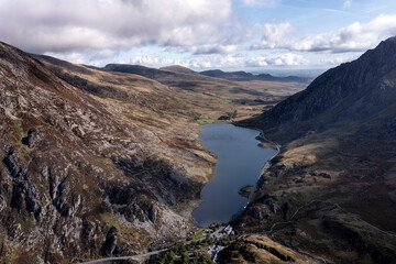 Fototapeta na wymiar Aerial view of flying drone Epic Autumn Fall landscape image of view along Ogwen vslley in Snowdonia National Park with moody sky and mountains