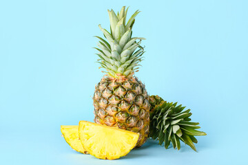 Fresh whole and cut pineapple on color background