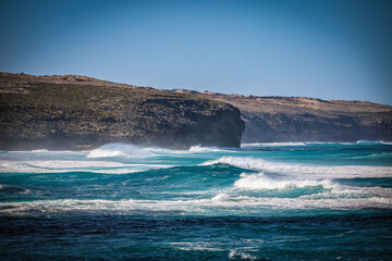 waves crashing on a rock